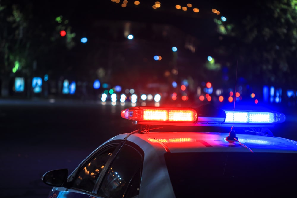 police car's red and blue lights shining at night in street