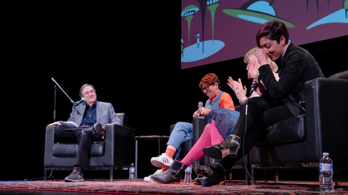 A panel of professionals and moderator on stage