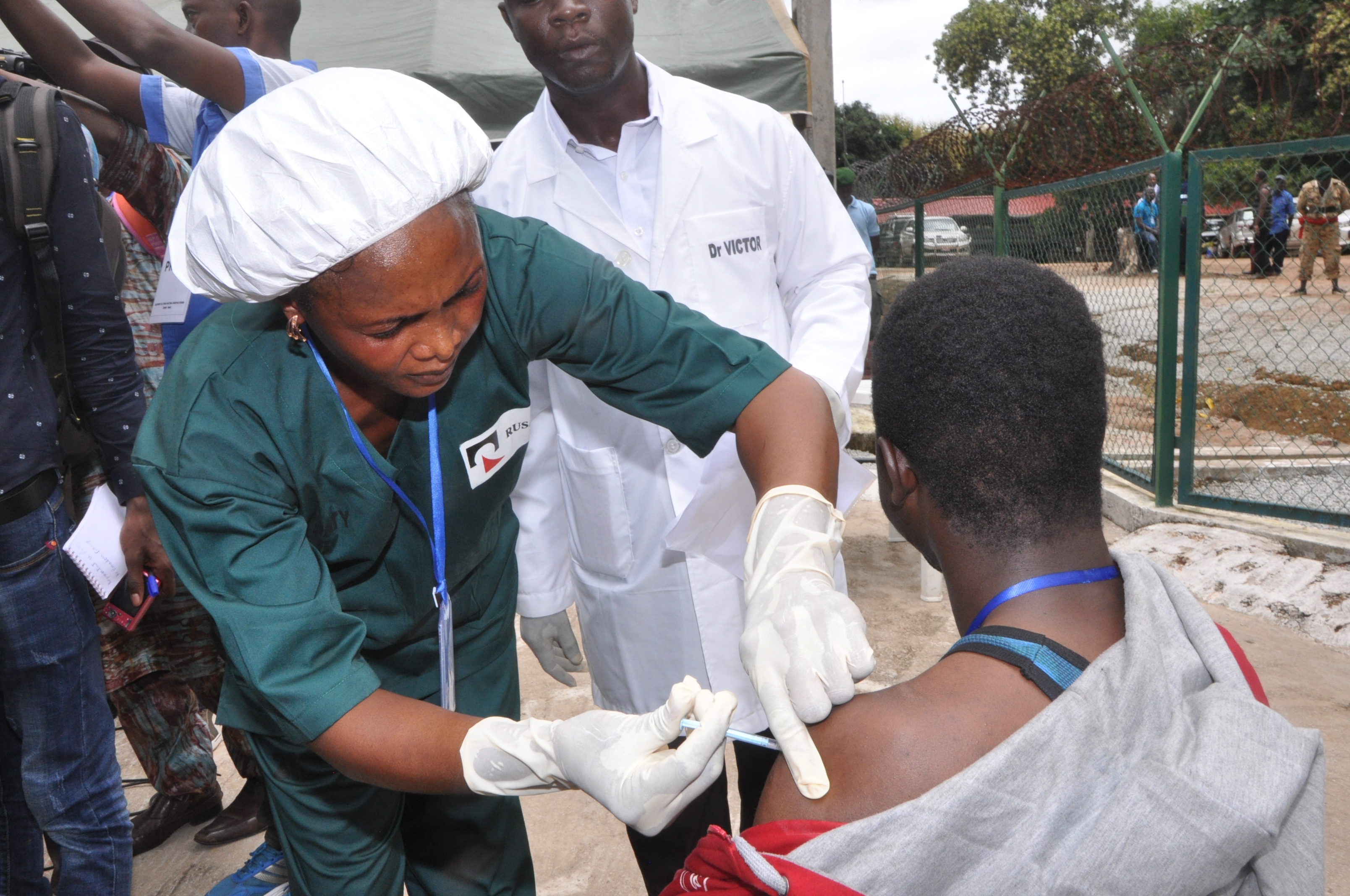 A person vaccinating another.