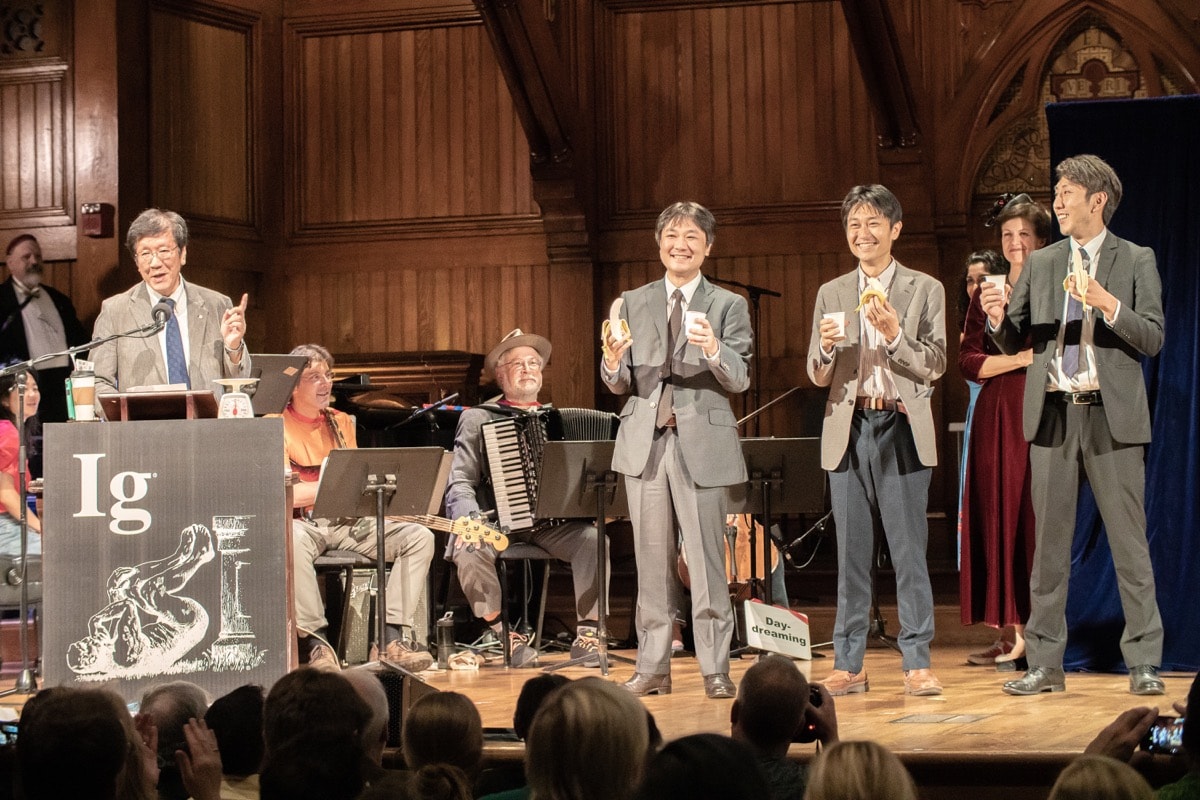 a group of scientists from japan on stage winning an award