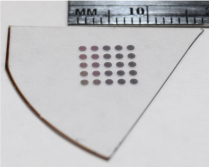 a grid of dots on a clear substrate. they are smaller than 10 millimeters