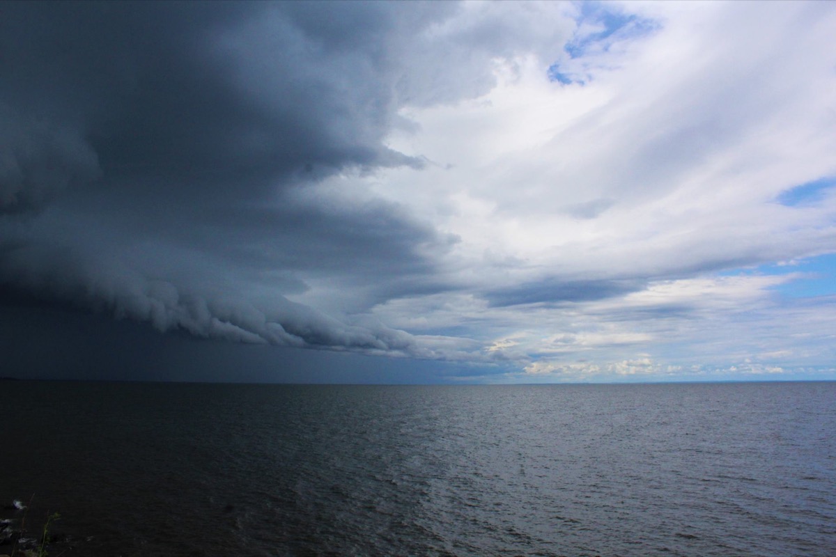 a storm brews over an expansive lake