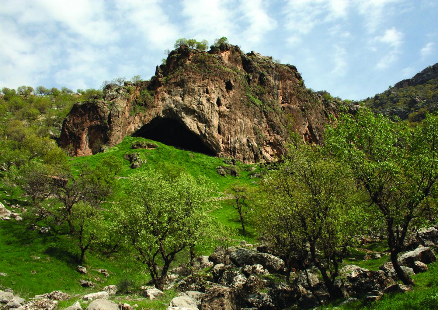 a landscape photo of greenery and a smallish mountain rising in the center of it