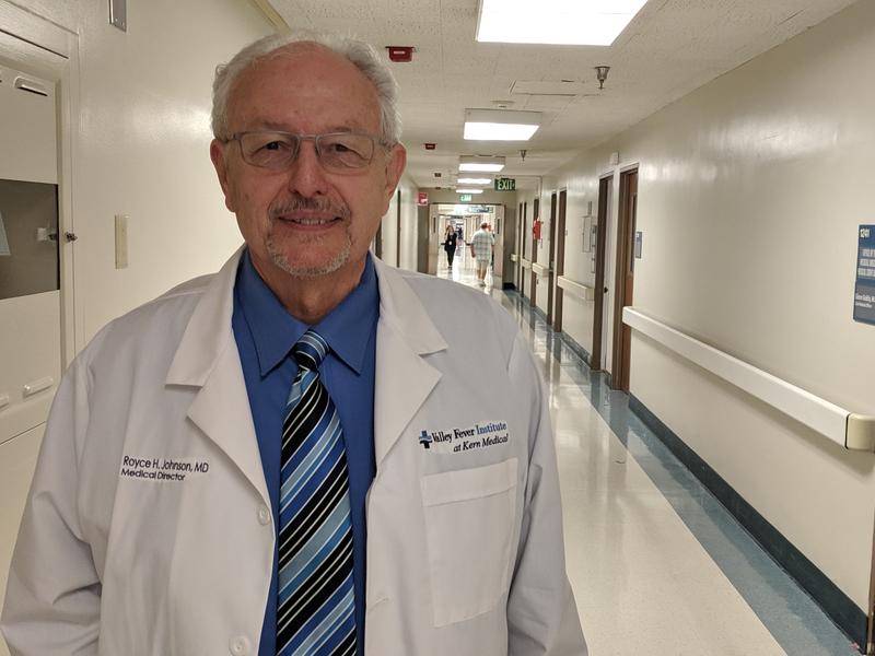 a older man in a white medical coat