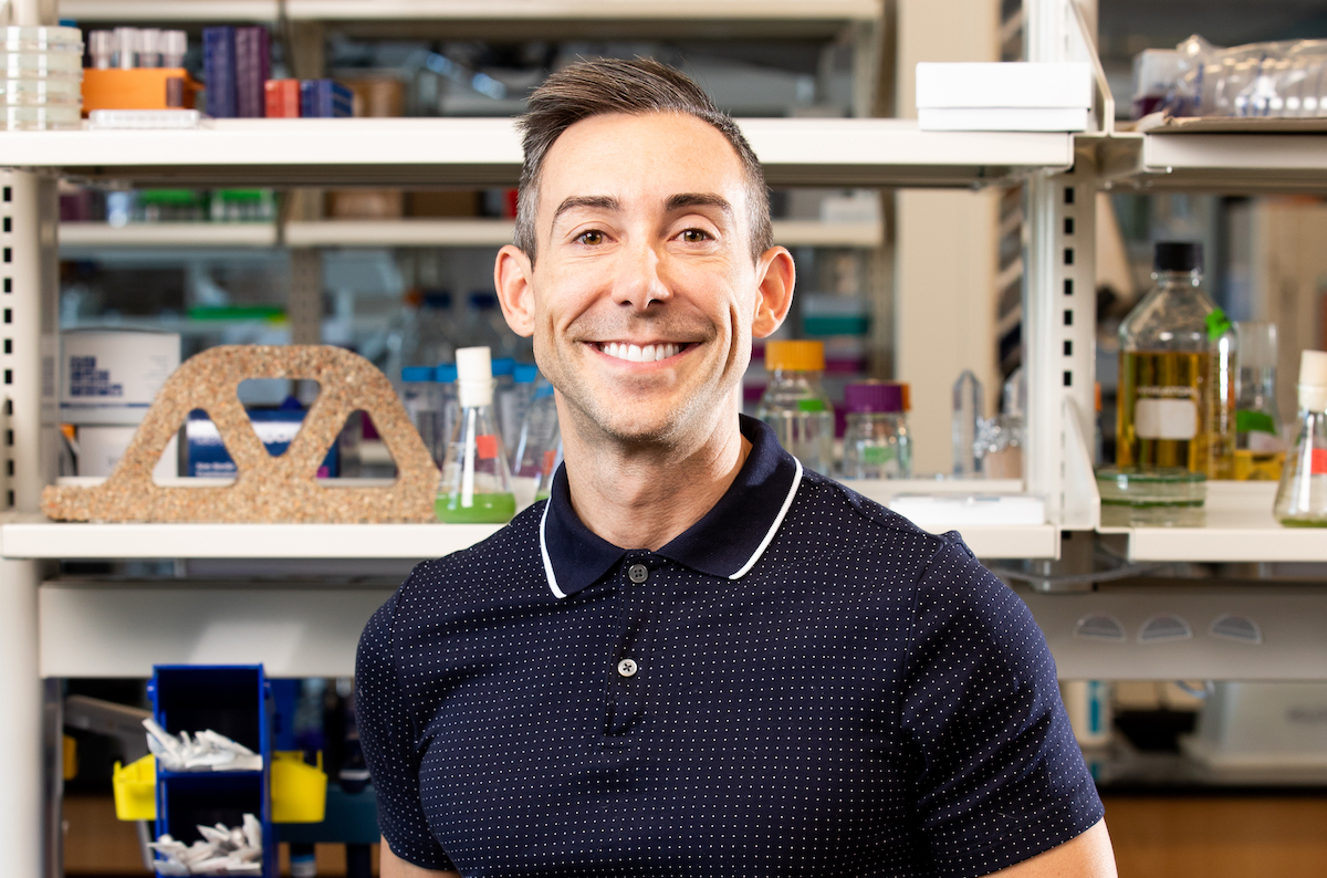 a man standing in a lab filled with different types of buildings materials