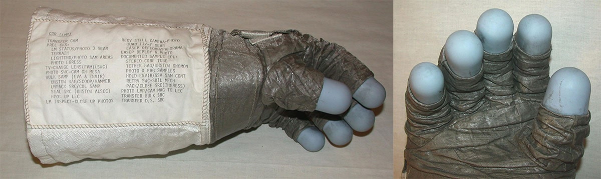 Side view, thumb up, of the left glove from an Apollo 11 spacesuit (left) and close up on the palm and blue finger pads of the same Apollo 11 glove (right)