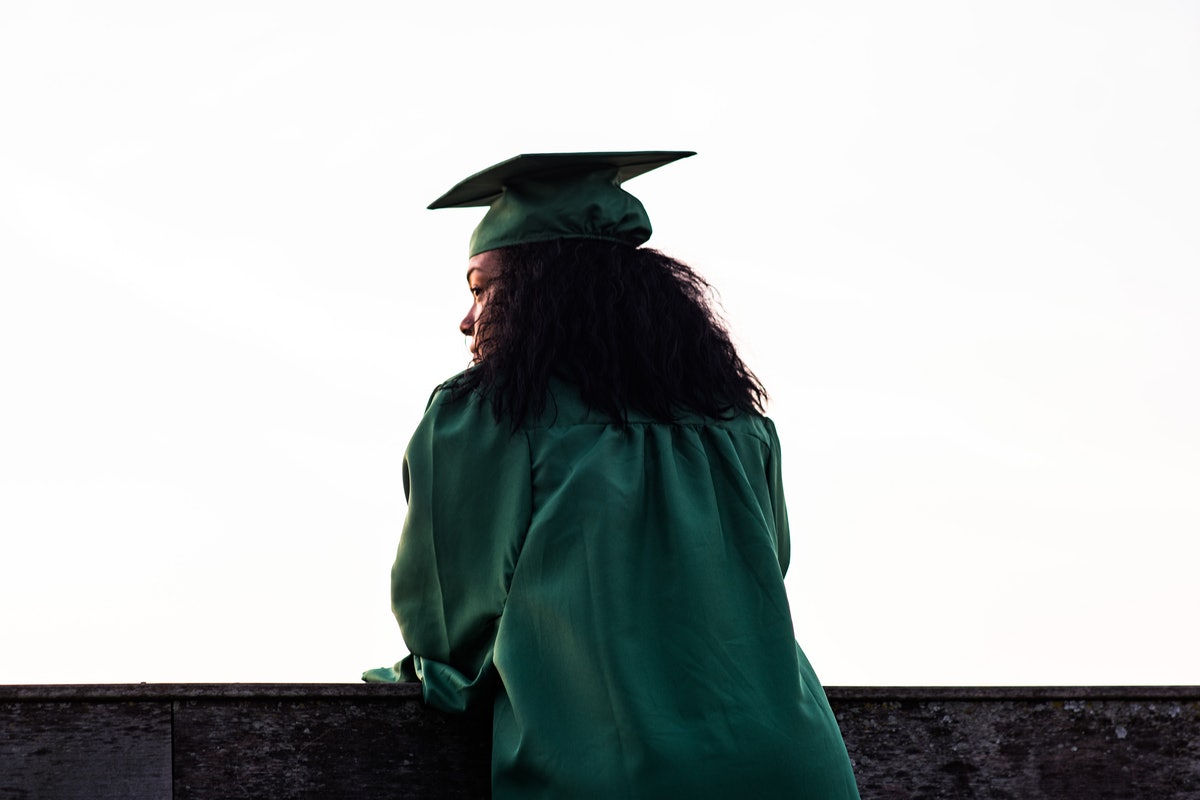 a female black student in a cap and gown