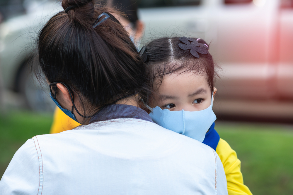 mother and little young daughter wearing mask for prevent the spread of the Covid-19 outdoor