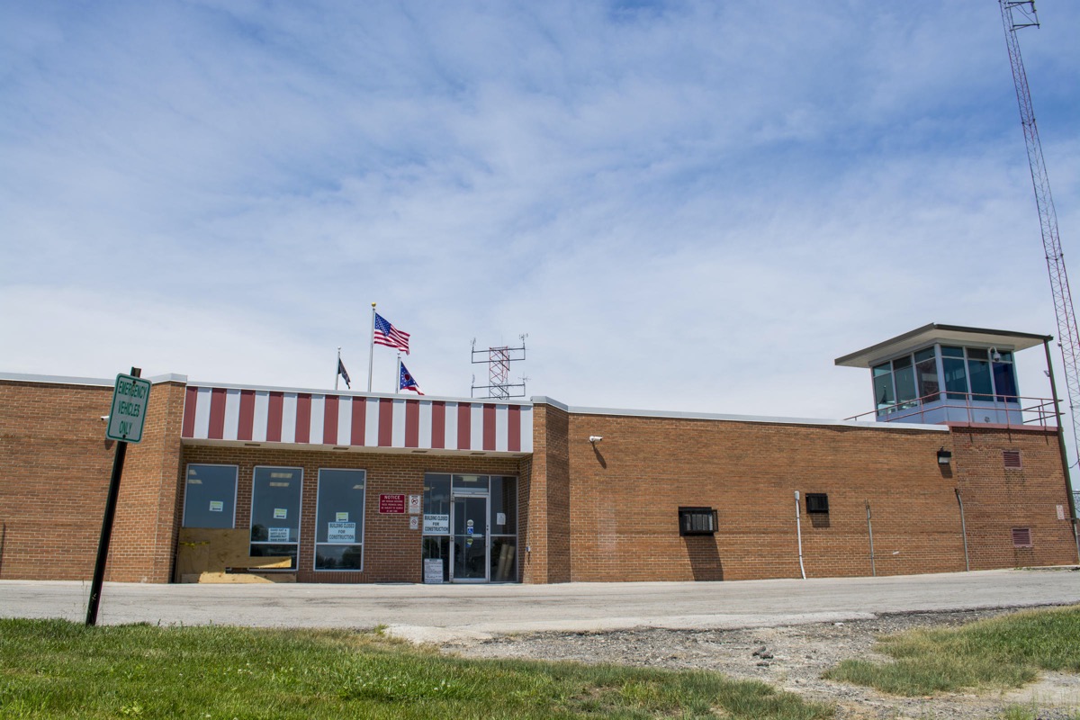 a brick building with a prison watch tower on the right.