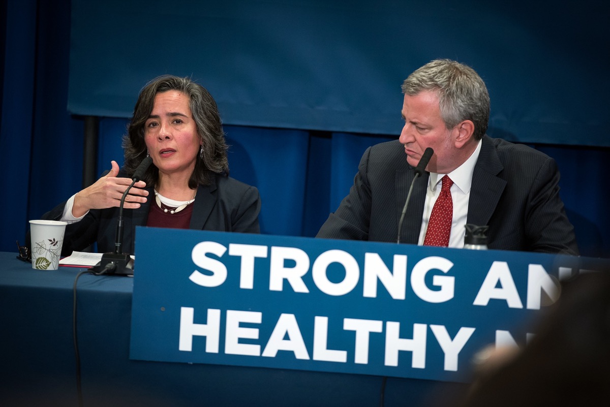 a woman and a man on a panel speaking