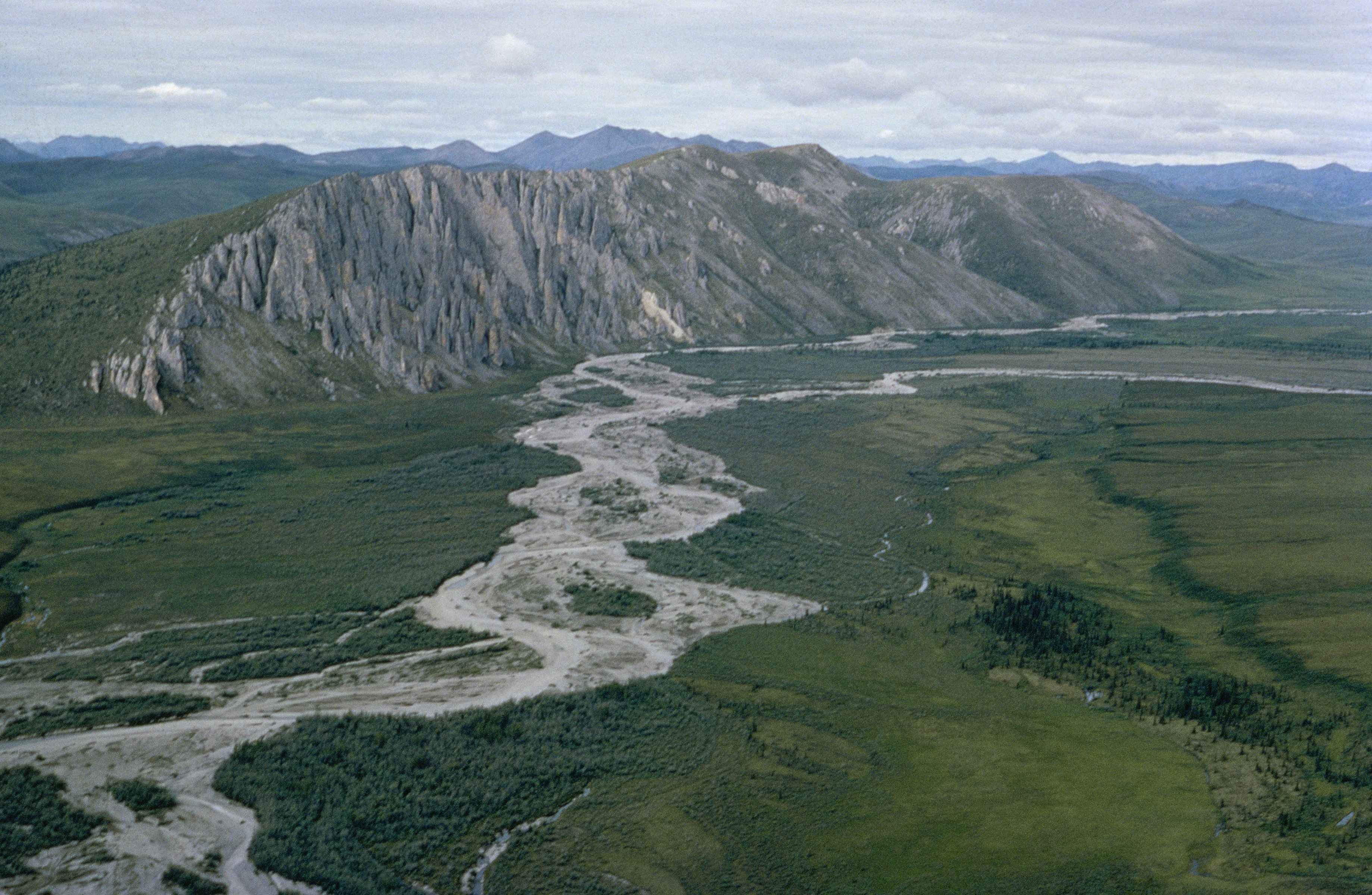 a landscape shot of mountains and a large long river