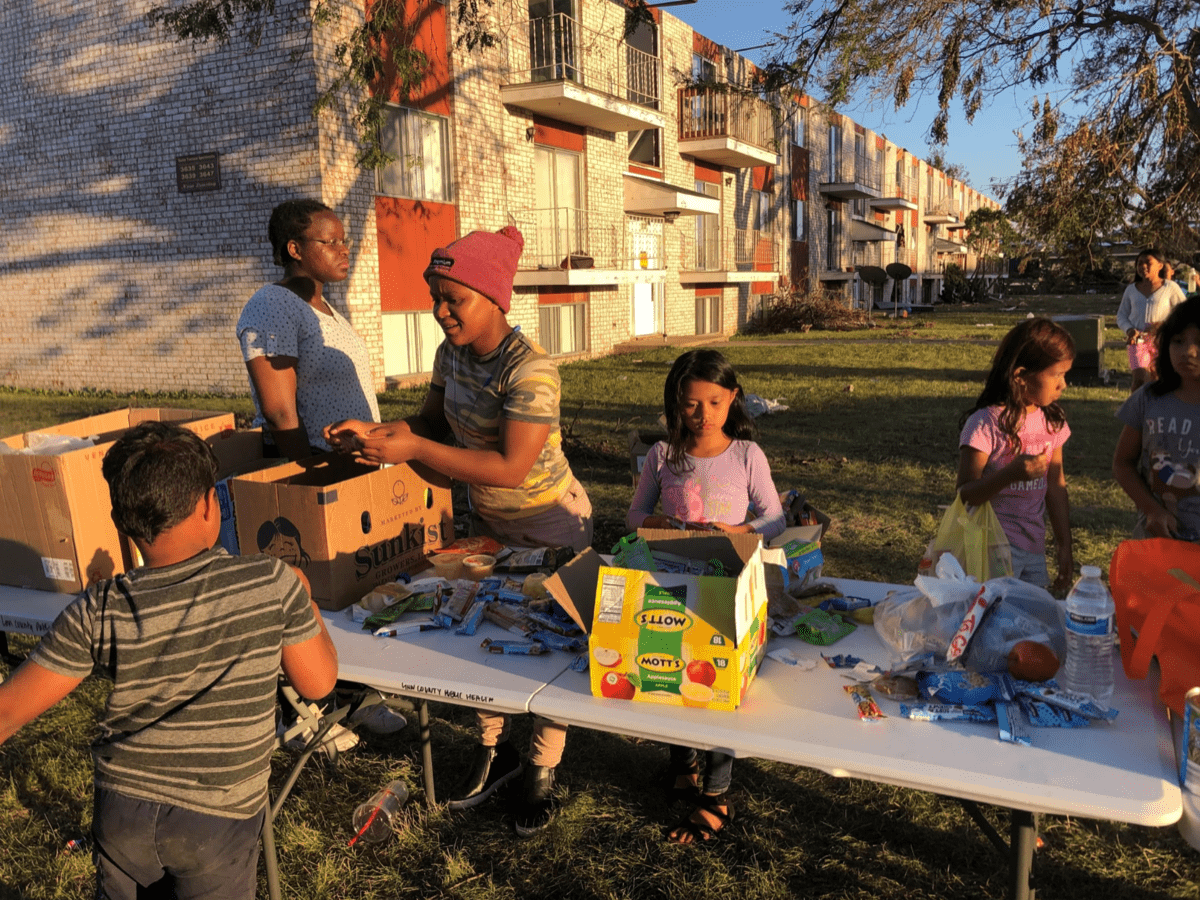 a family at a table full of emergency supplies