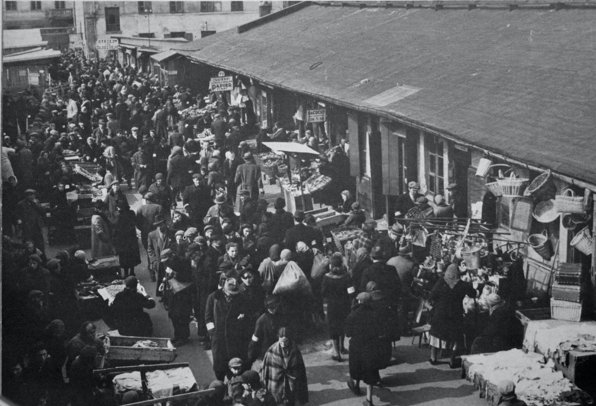 a black and white image of a crowded market in a ghetto