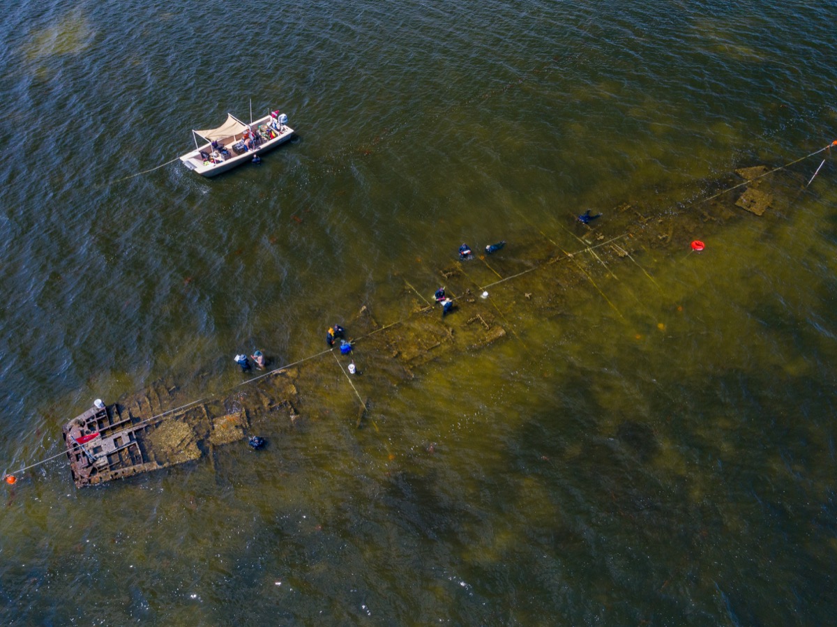 an aerial view of a shipwreck in a shallow bay