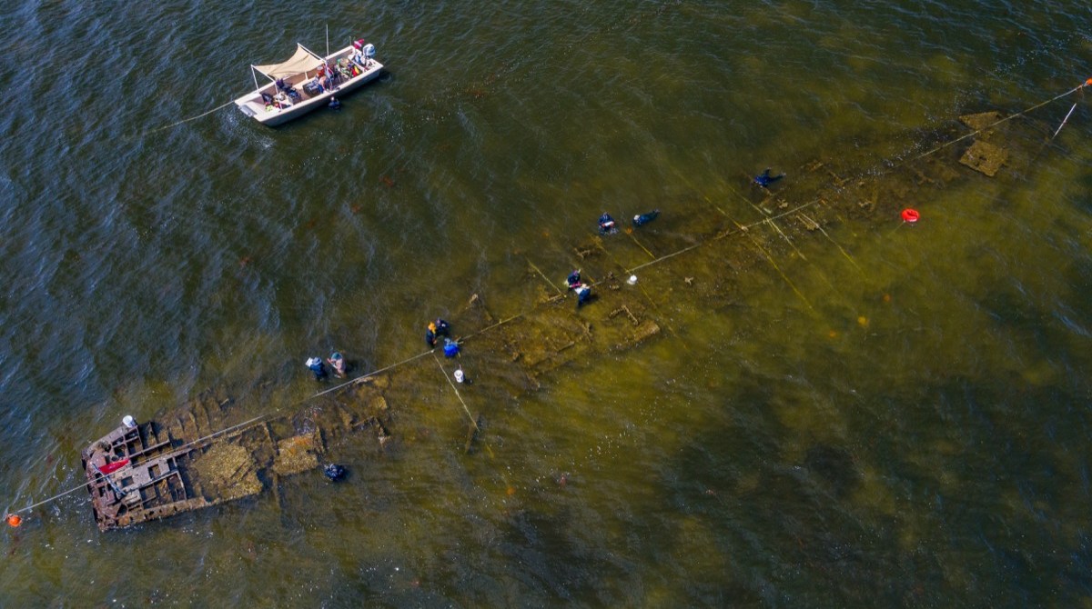 an aerial view of a shipwreck in a shallow bay