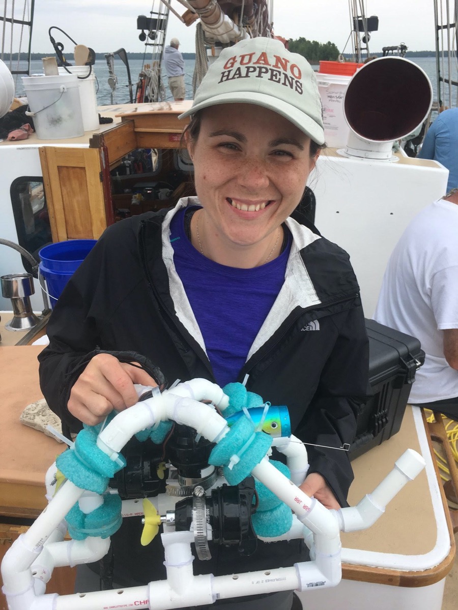 a woman in a hat holding experimental tech