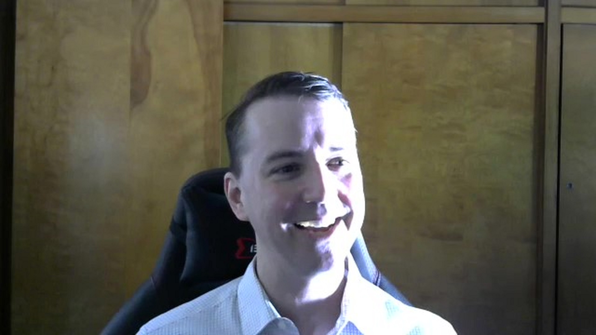 a screenshot of a video chat of a White man talking and smiling