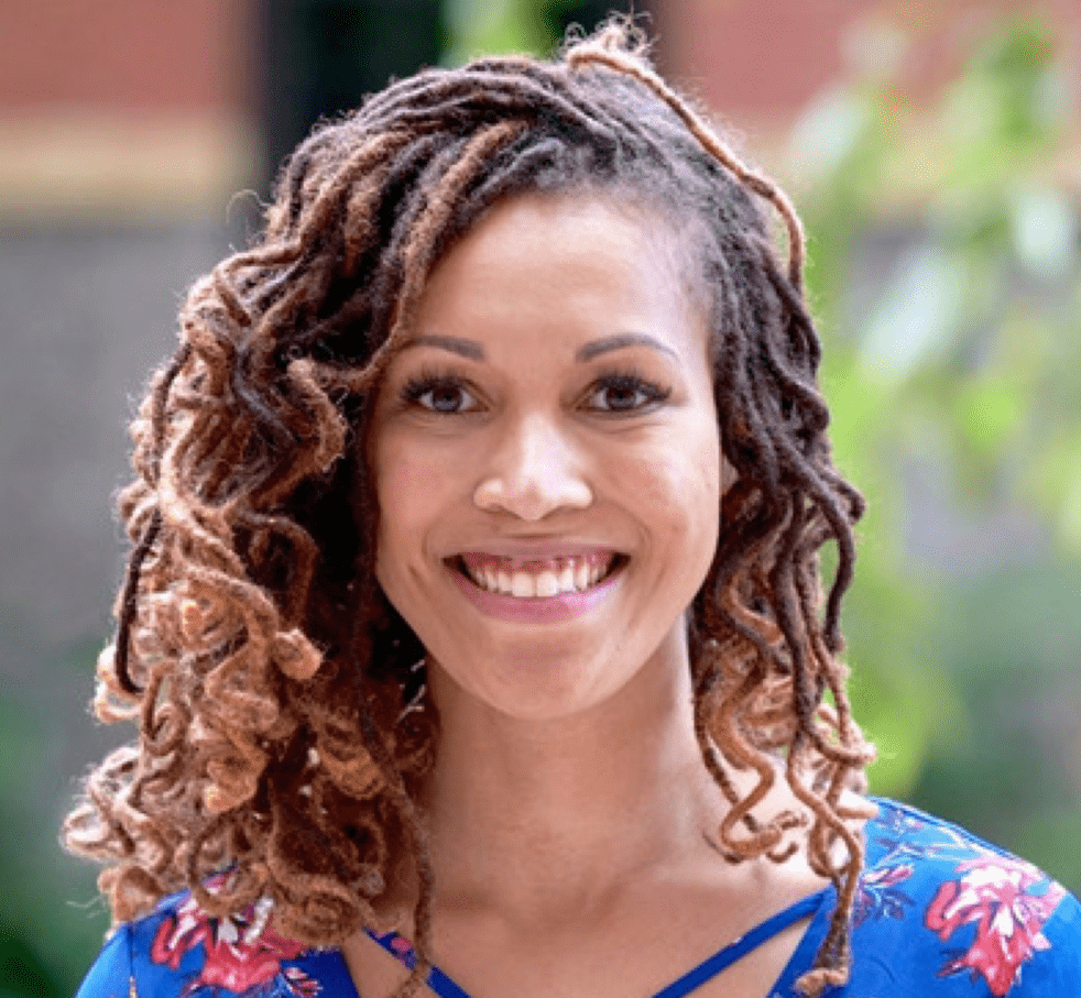 a portrait of a black woman in a blue flower shirt