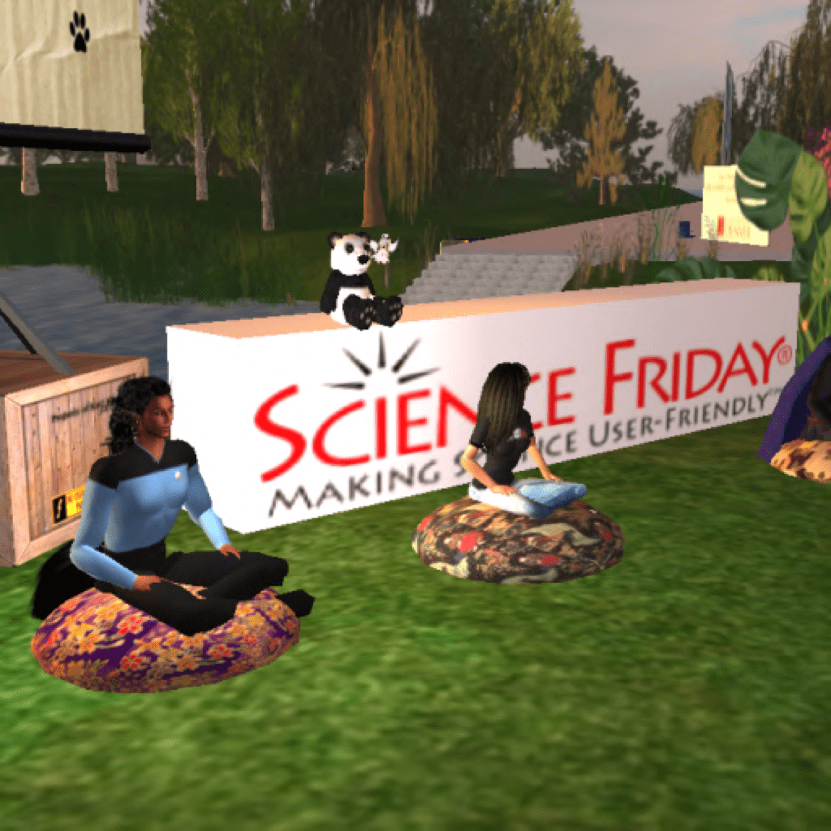 a virtual world where a star trek uniformed avatar and a female presenting avatar with brown hair sits on cushions in a circle. behind them is a sign that reads "science friday making science user-friendly." a panda bear sits atop the sign