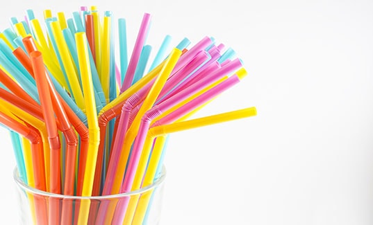 cup of plastic straws