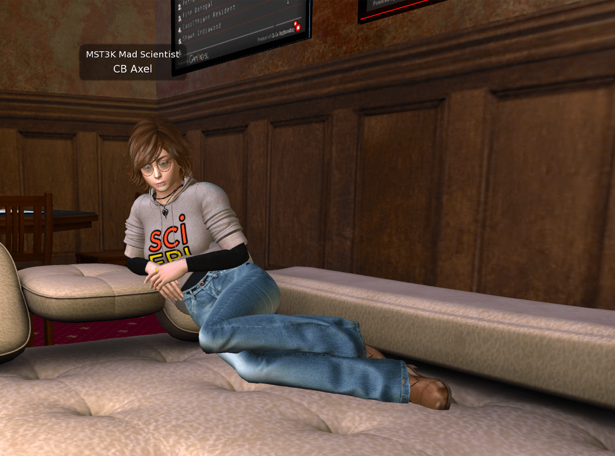 a virtual world avatar woman with a pixie haircut, glasses, and a gray scifri hoodie. she is lounging on a couch