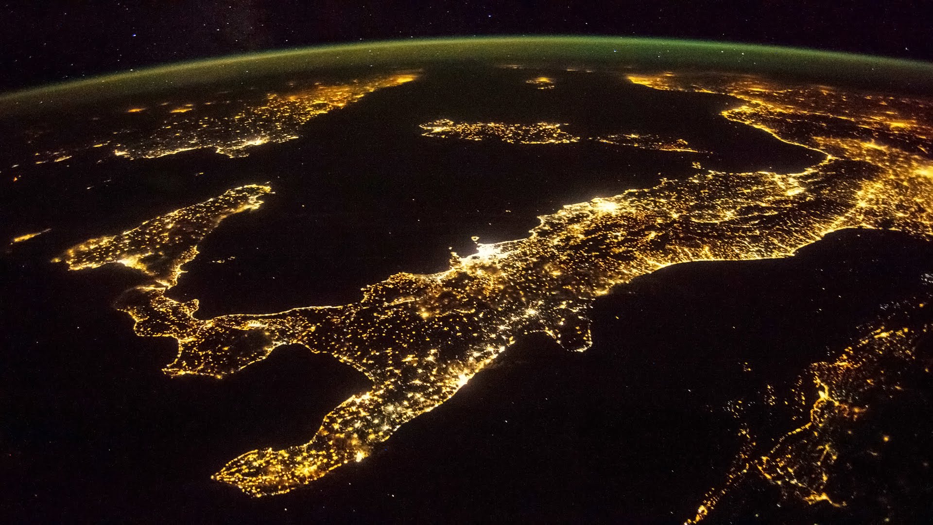 italy from space at night, with millions of lights shining