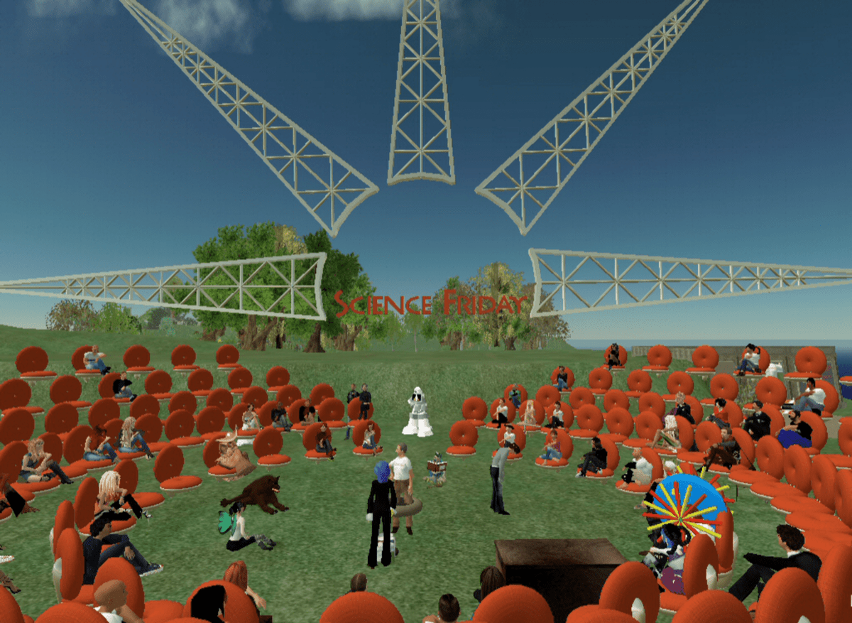 a virtual world from the late 2000s, showing an ampitheater of avatars arranged in a circle on an island. in the background is a big scaffolding structure of a sun and the science friday logo