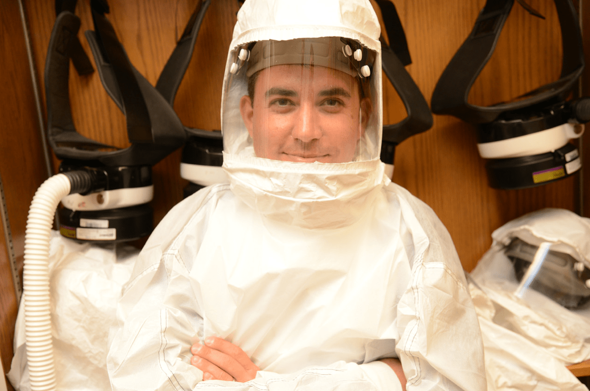 a male scientist in a hazmat suit to study coronaviruses in a biosafety lab