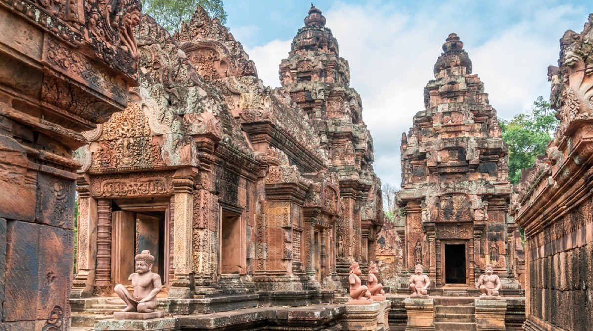 an ancient stone temple with various intricate towers and turrets