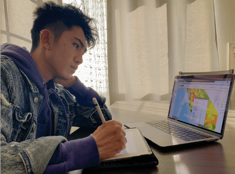 Student lookong at CalEnviroScreen maps on a laptop.