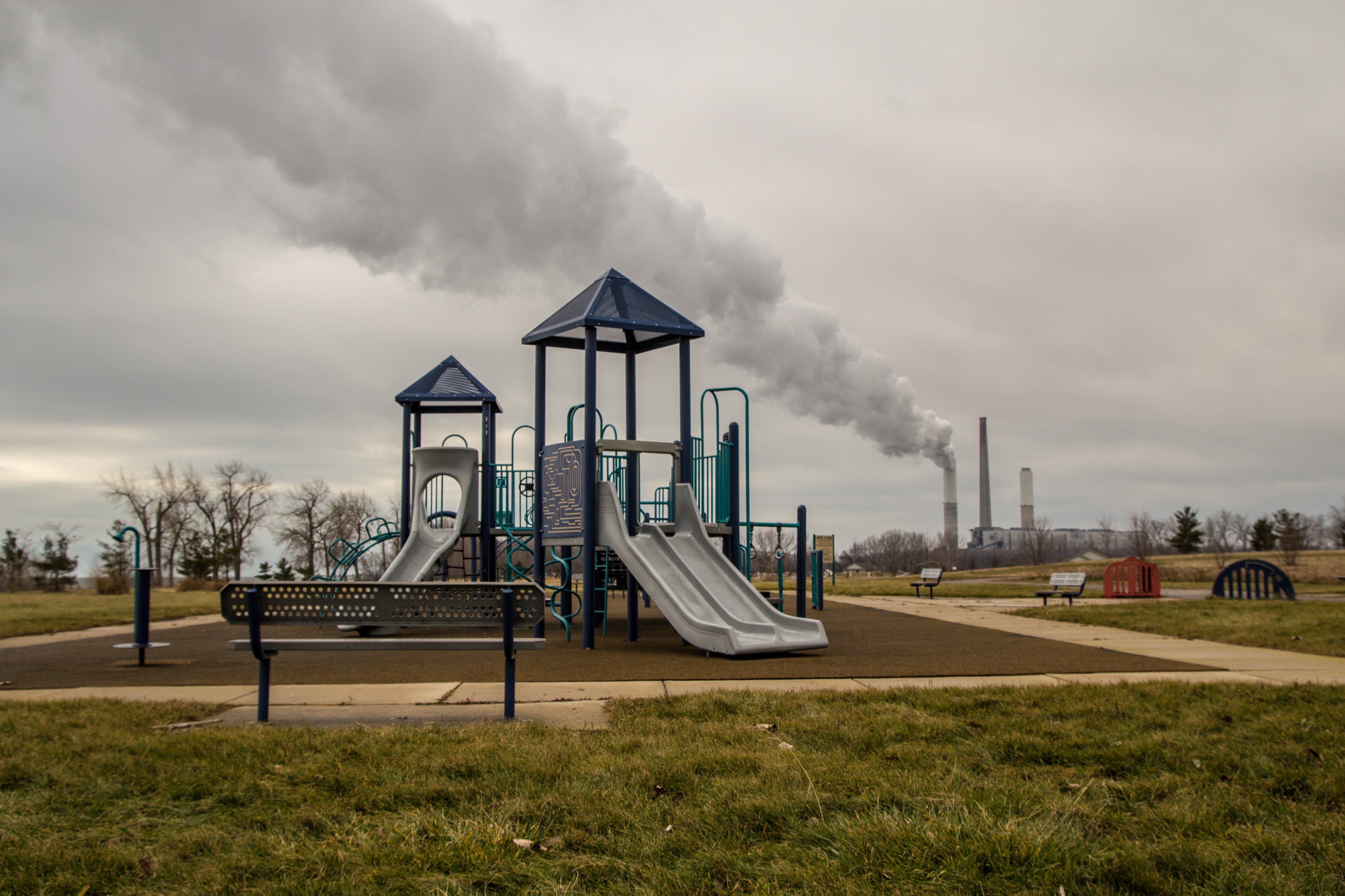  Playground at Sterling State Park with billowing smokestack in the background.