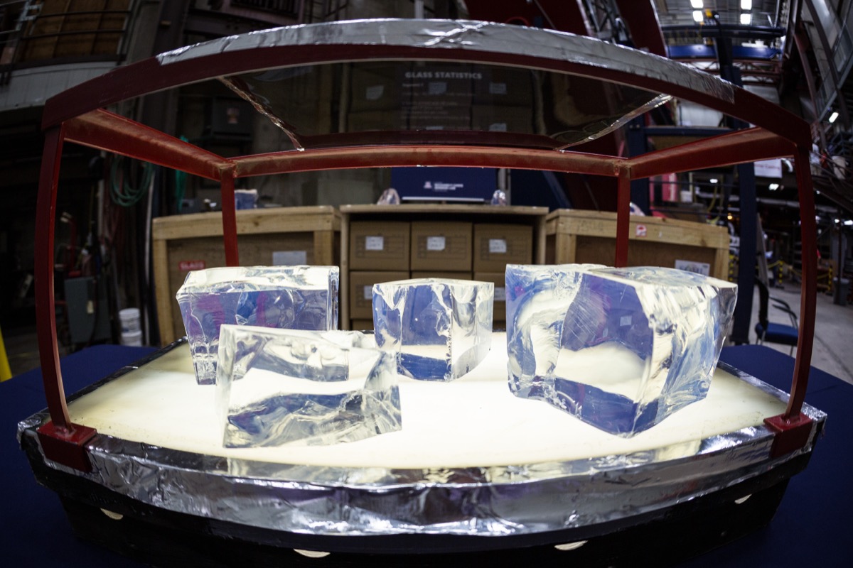 cube chunks of glass sitting in the dark under a light in a sort of display case