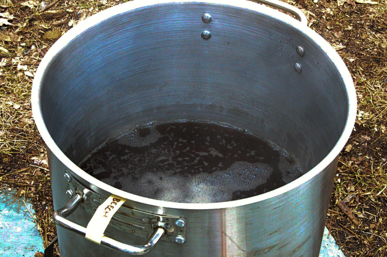 a stainless steel pot barely filled with syrup