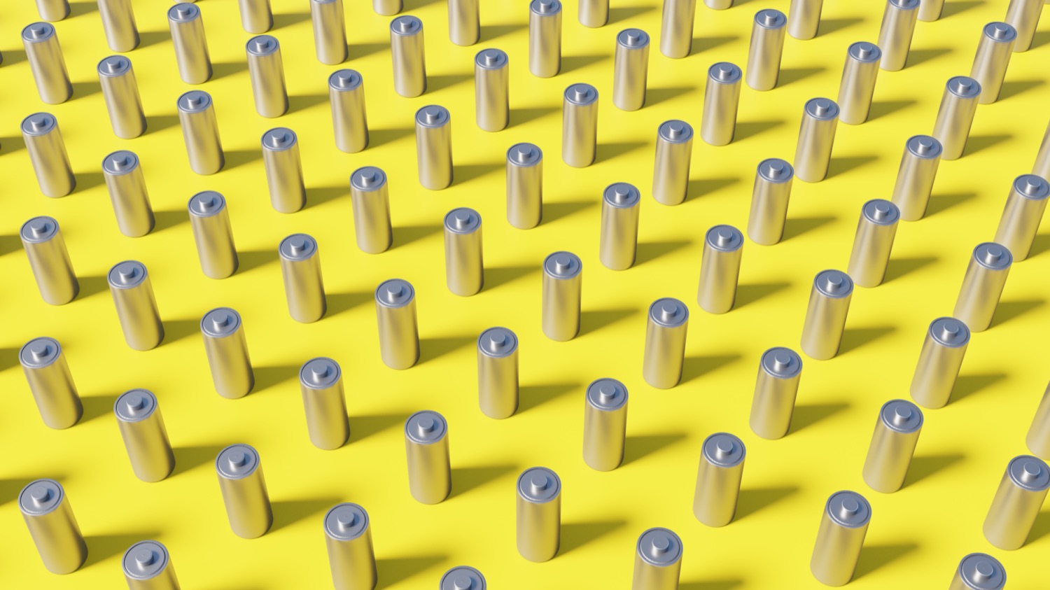 dozens of rows of AA batteries on a yellow background