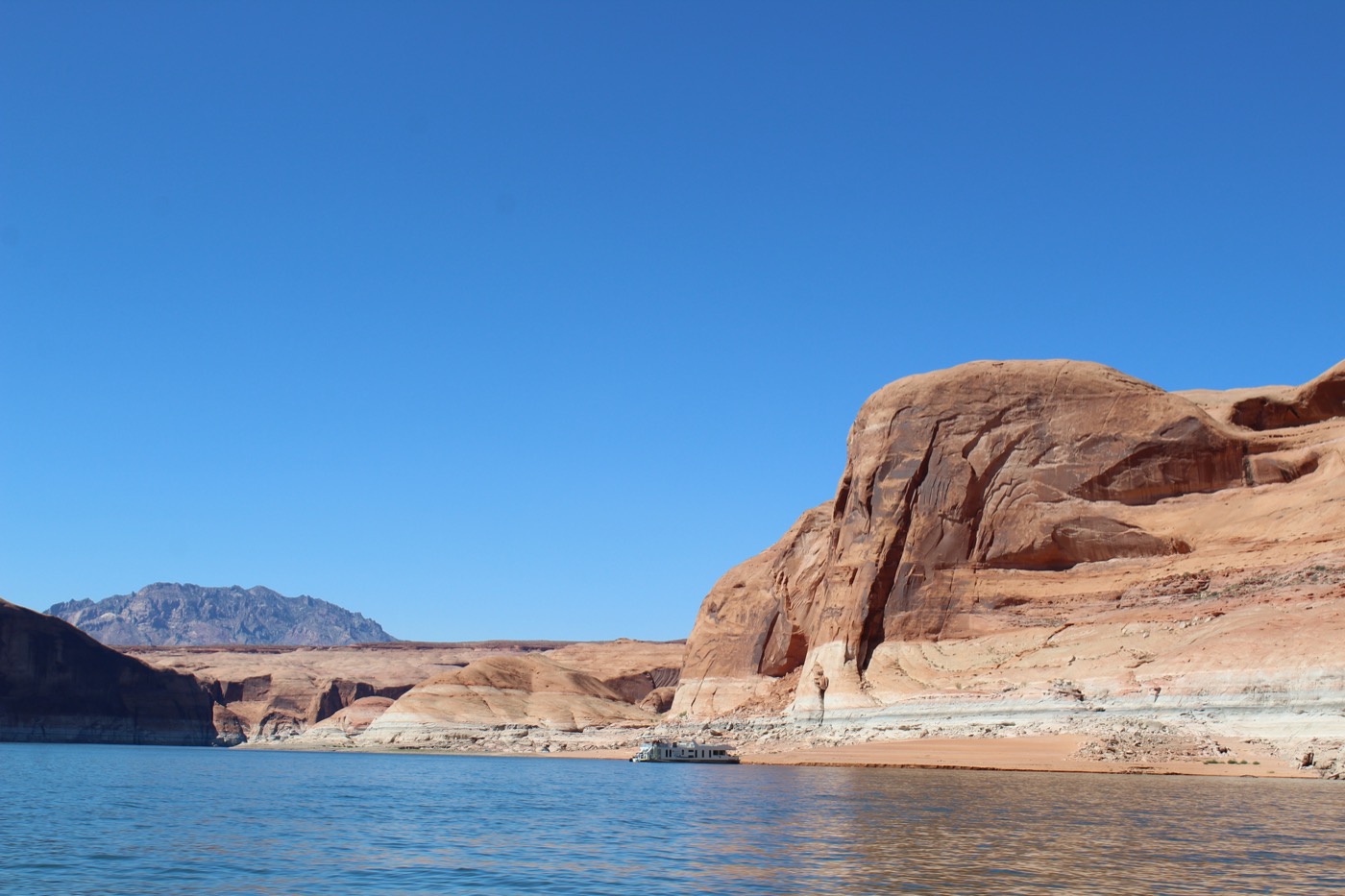 a landscape shot of desert mountains and a lake. you can tell by lighter colors on the canyon wall that the water level has receded