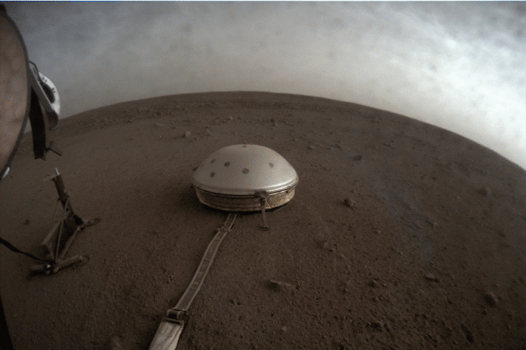 a white dome structure on a dusty desert landscape with clouds moving overhead