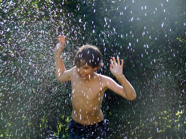 a young boy running through the rain