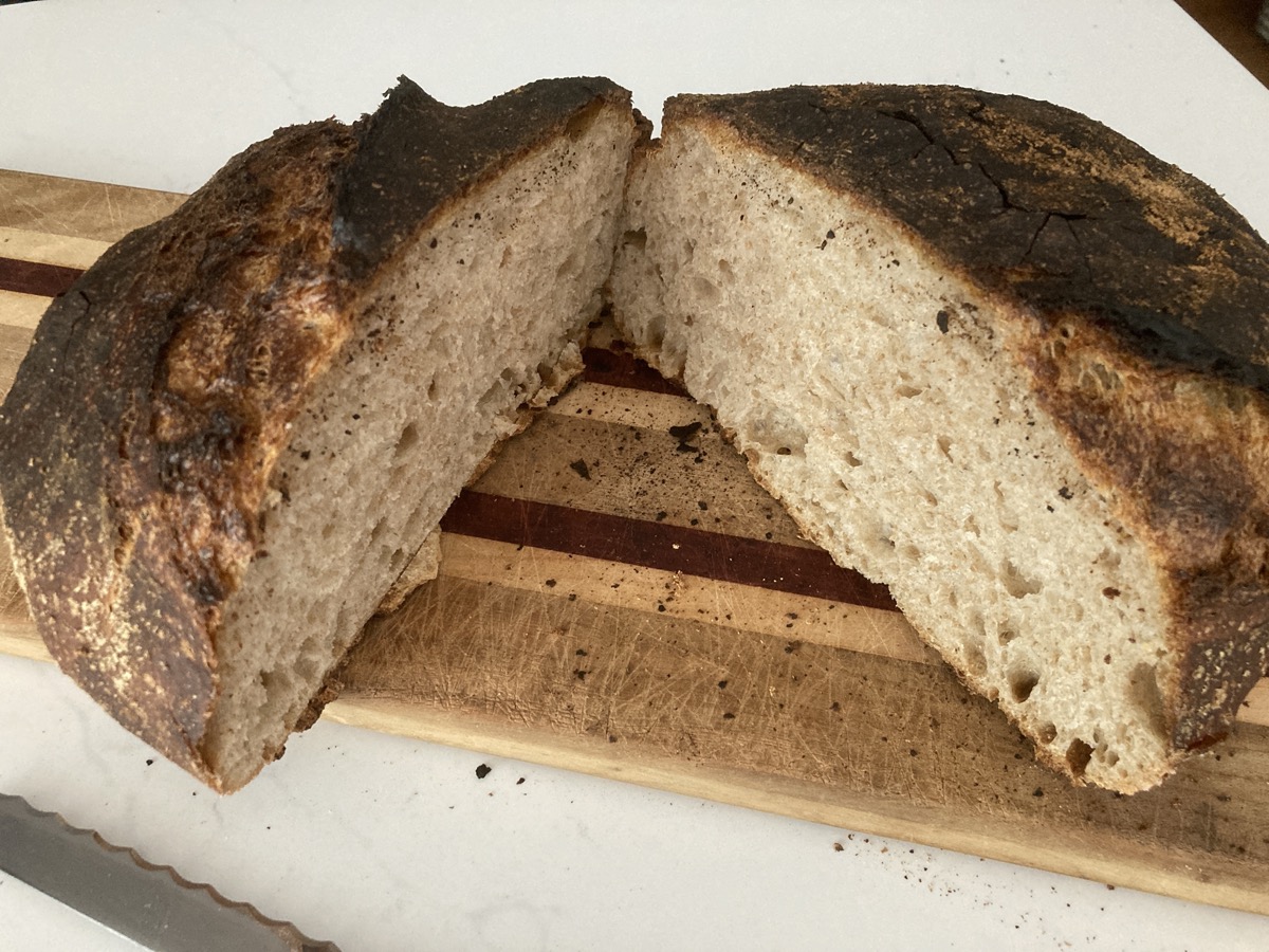 a loaf of sourdough bread sliced in the middle to see its rich density 