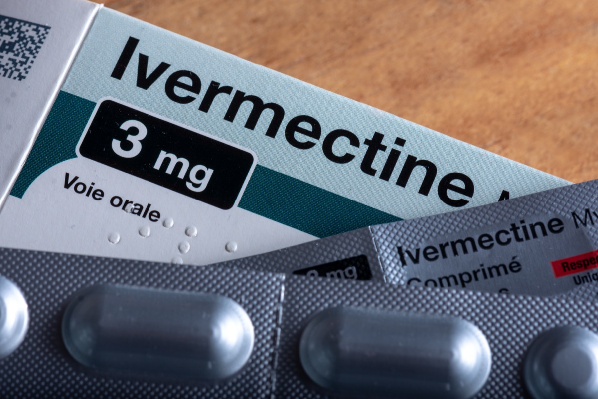 a box of medicine labeled ivermectin with pill packets lying on top