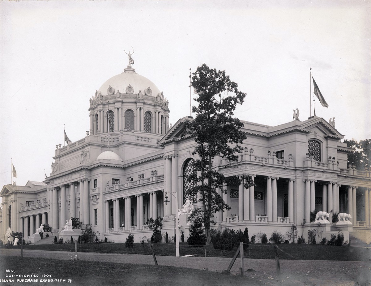 a black and white photo of an opulent building with a large rotunda and pillars