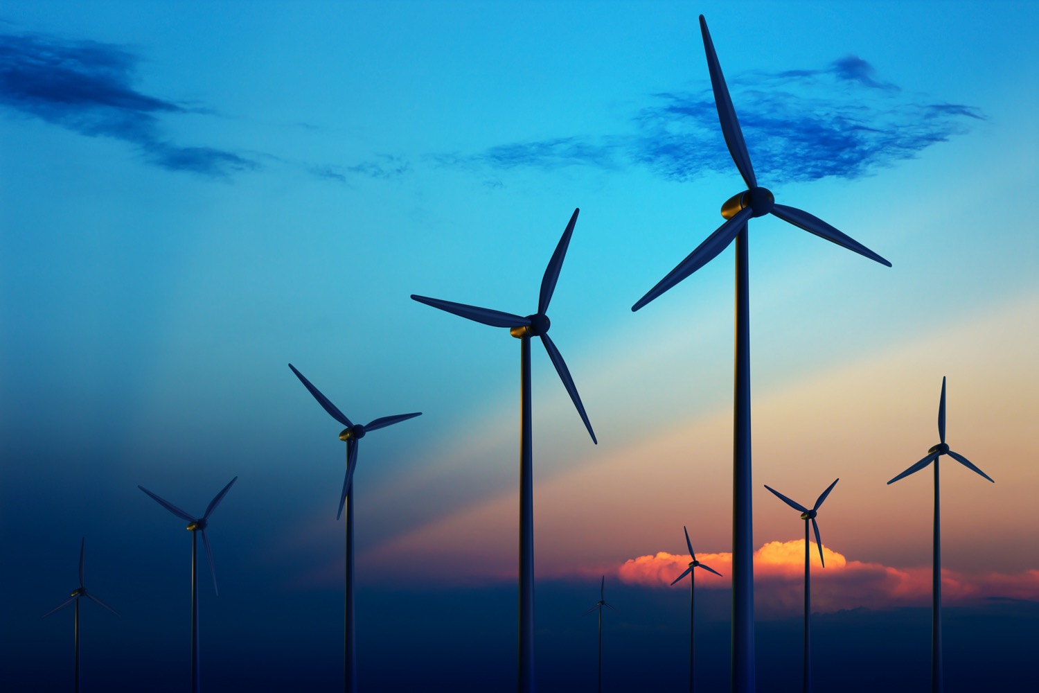 seven wind turbines silhouetted by sunrise