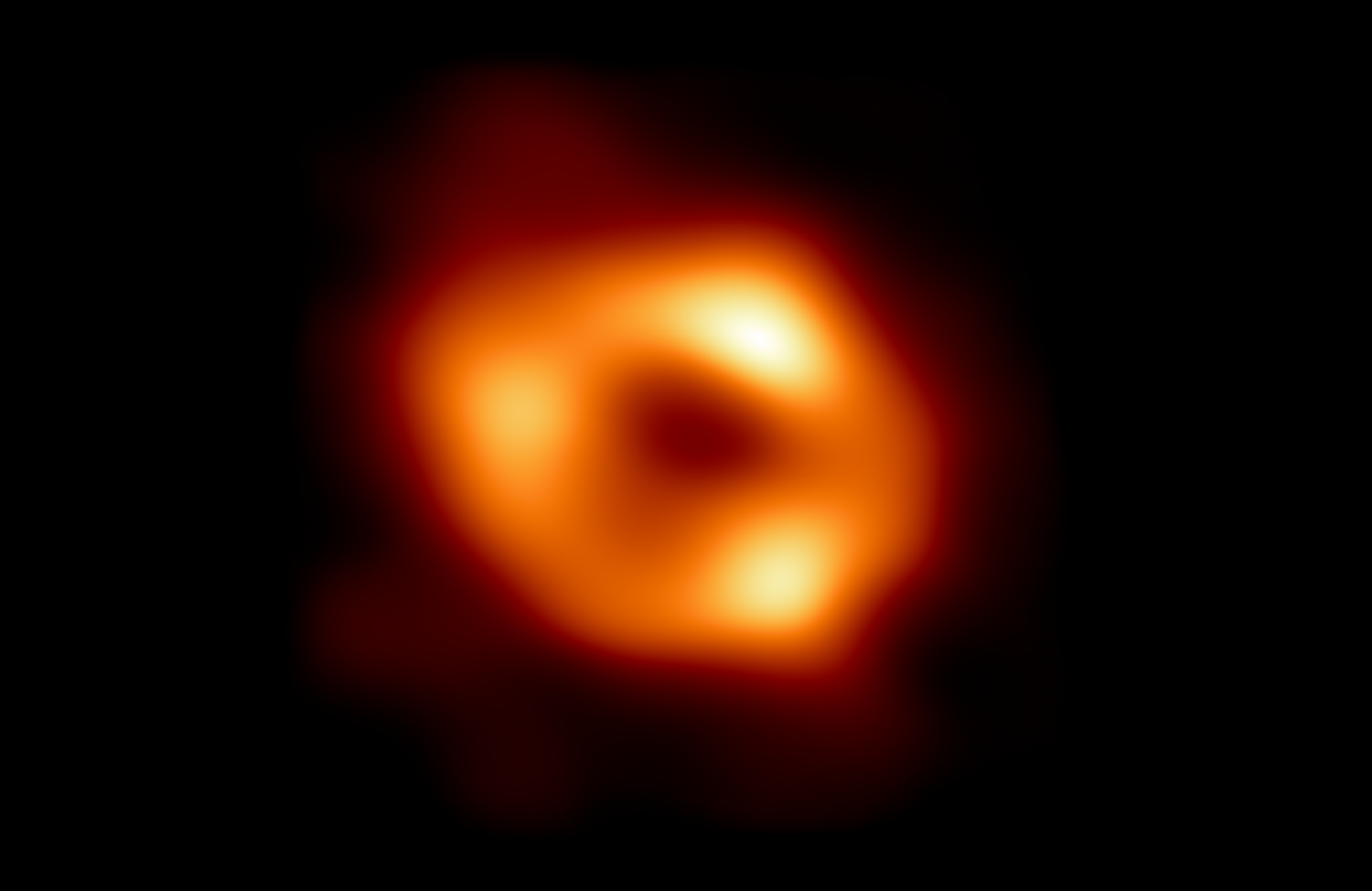 a glowing ring that looks a bit like an orange donut. this ring represents the gas orbiting around the black hole