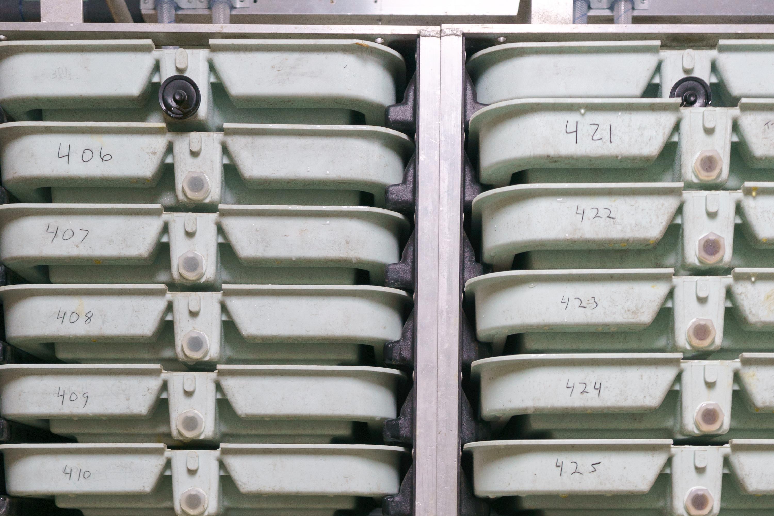 two columns of a dozen trays on a rack