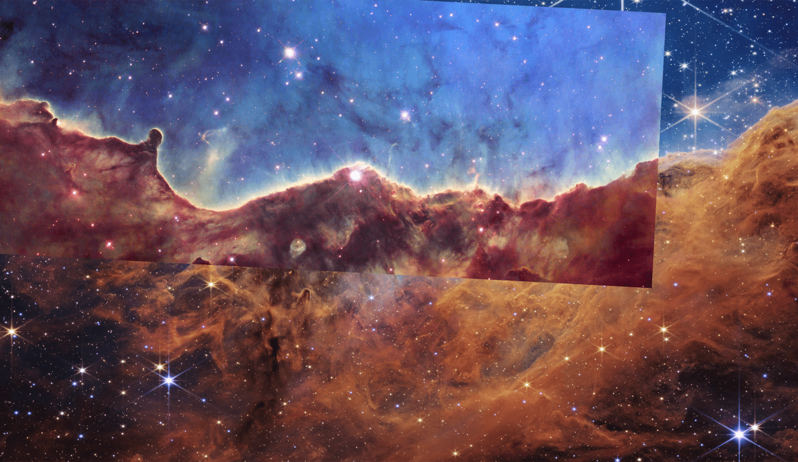 Two images of the same image laid on top of each other. The one on top, smaller than the one below it, is a Hubble image of the Carina Nebula shows the same region as a new Webb telescope image. Hills and valleys of gas and dust are displayed in intricate detail, cutting through a star-forming region. Wispy tendrils of gas, as well as dark trunks of dust, are set amid a backdrop of soft, glowing blue light. The glowing nebula has been carved out by intense ultraviolet radiation and stellar winds from several hot, young stars. The image also reveals dramatic dark towers of cool gas and dust that rise above the glowing wall of gas. The dense gas at the top resists the blistering ultraviolet radiation from the central stars, and creates a tower that points in the direction of the energy flow. the other from the jwst, is divided horizontally by an undulating line between a cloudscape forming a nebula along the bottom portion and a comparatively clear upper portion. Speckled across both portions is a starfield, showing innumerable stars of many sizes. The smallest of these are small, distant, and faint points of light. The largest of these appear larger, closer, brighter, and more fully resolved with 8-point diffraction spikes. The upper portion of the image is blueish, and has wispy translucent cloud-like streaks rising from the nebula below. The orangish cloudy formation in the bottom half varies in density and ranges from translucent to opaque. The stars vary in color, the majority of which, have a blue or orange hue. The cloud-like structure of the nebula contains ridges, peaks, and valleys – an appearance very similar to a mountain range. Three long diffraction spikes from the top right edge of the image suggest the presence of a large star just out of view.