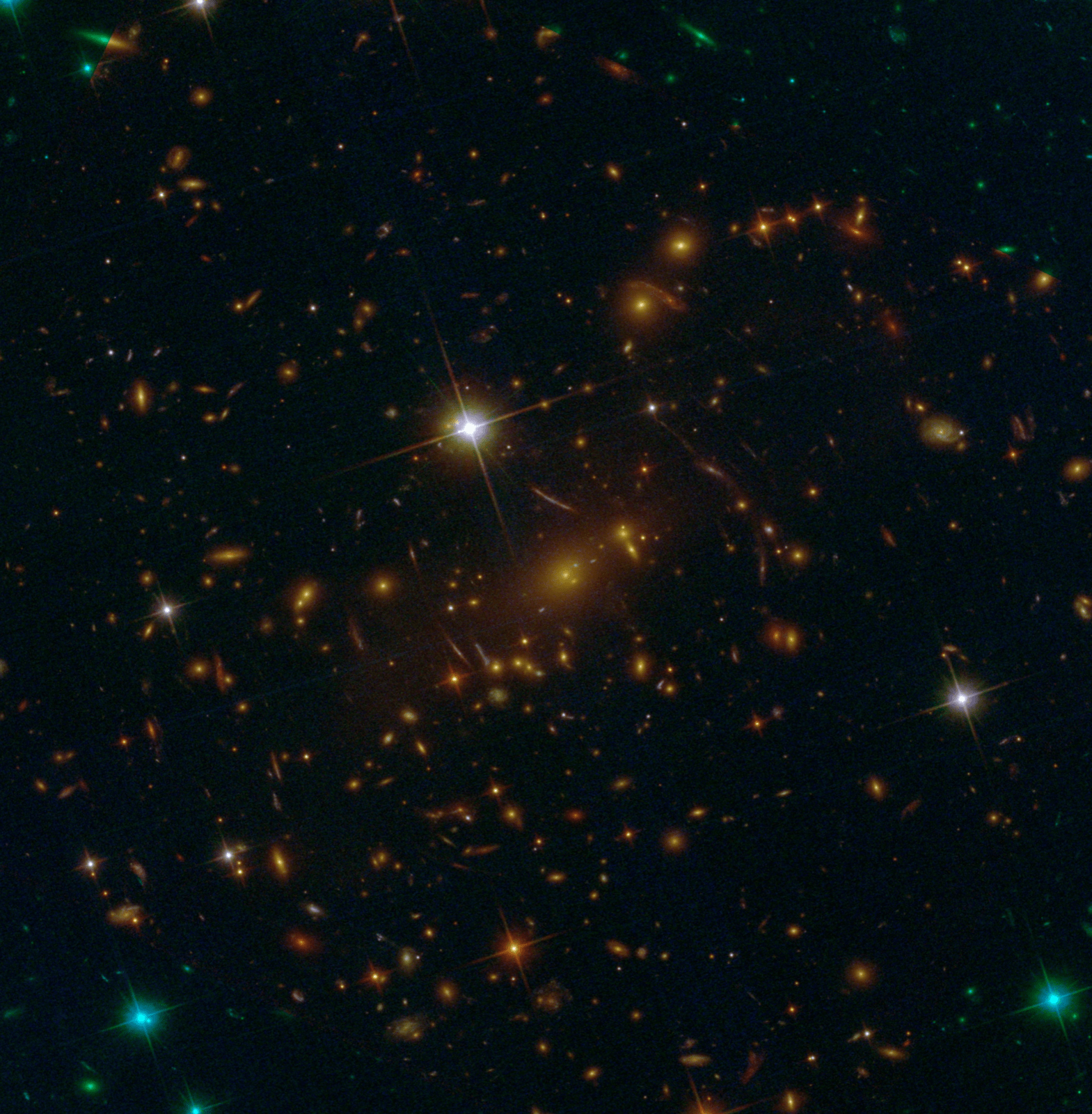 This image, captured by Hubble, shows three stacked, filtered views of galaxy cluster SMACS 0723 as captured by two of Hubble’s instruments. An infrared view of the galaxy cluster is on top of the stack. Only the edges of the bottom two layers of the stack are visible, like messily stacked papers. There is one layer that is identifiable by its green filters and another by its blue filters. The background is dark with many galaxies scattered across it.