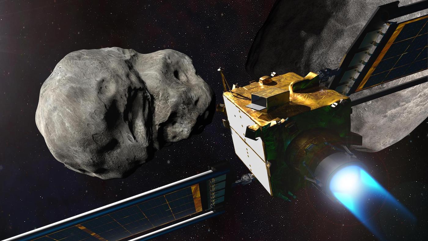A small rectangular yellow spacecraft with a jet emitting blue flame flies toward a large grey asteroid.