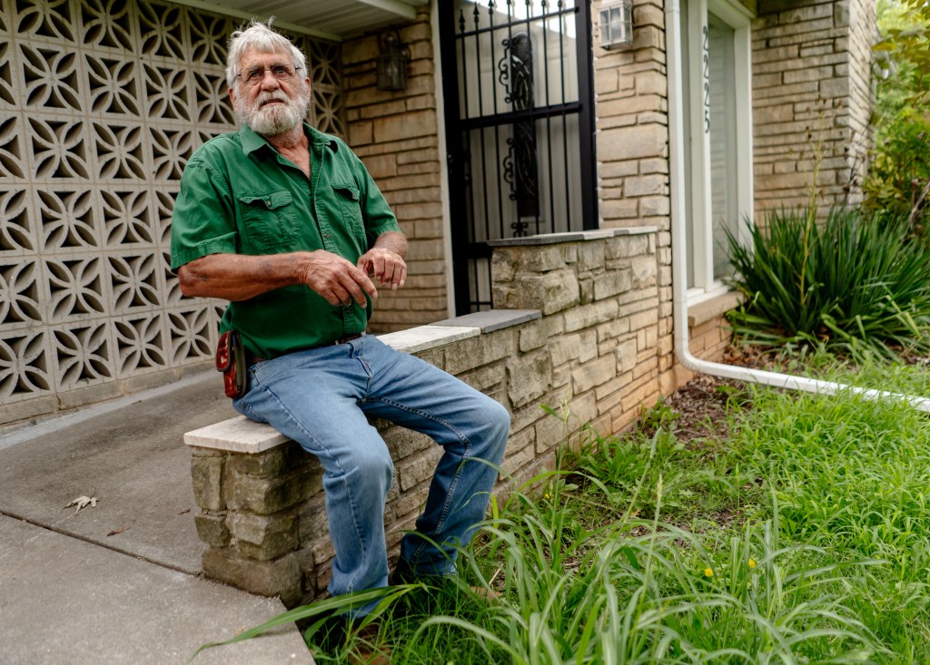 A man sitting on his front porch. 