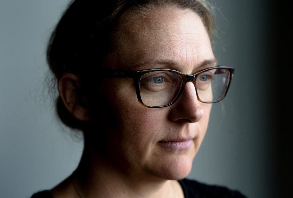 Close up of a woman's face, looking disappointed and pensive.