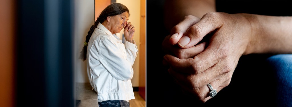 A woman wipes a tear away, on the right is a pair of hands with fingers locked together