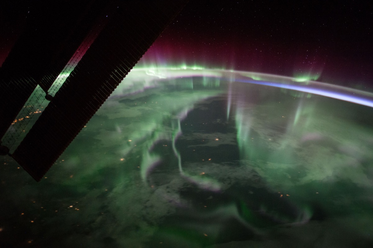 Wavy, translucents layers of auroras in red, green, and purple.